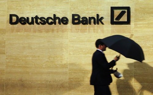 A man walks past Deutsche Bank offices in London December 5, 2013. REUTERS/Luke MacGregor (BRITAIN - Tags: BUSINESS) - RTX1657A